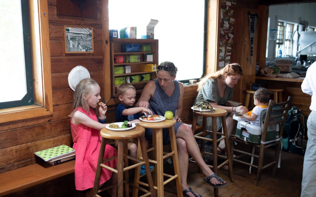 Head Cook Anna Ashby (right) and Summer Manager Lindsay Clarke (left) have lunch with their children.